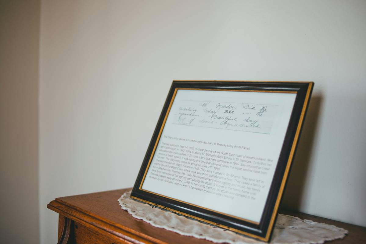 memory shadow box ideas featuring vintage concert tickets and a small medal arranged on navy fabric