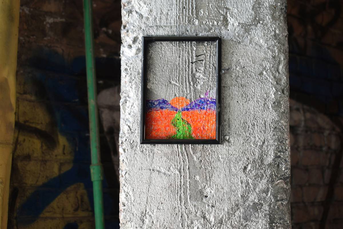shadow box home decor displaying vintage keys and pressed flowers on a white wall